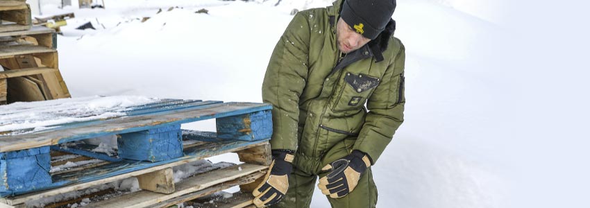 Man wearing Heritage gear working in the snow